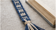 A narrow woven band used as a bookmark